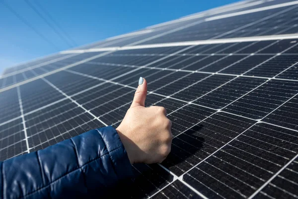 Close up hand of young female engineer checking solar operation and cleanliness of photovoltaic solar panels in the sun. Concept renewable energy sources. technologies. electricity services future.