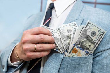 young man in a suit counts the money, finance conept. close up