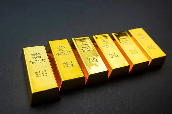 Stack of golden bars isolated on black background. Financial  investment and wealth concept.