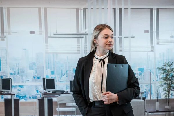 stock image Young caucasian businesswoman with clipboard posign at office. 