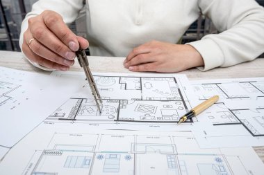 man throws sketches of drawings on paper with laptop. Designer makes sketches