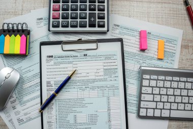 1040 tax form with pen and calcultor on desk, paperwork and accounting conept