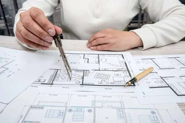 man throws sketches of drawings on paper with laptop. Designer makes sketches