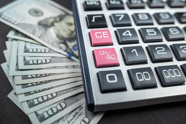 Para dolarları ve hesap makinesi siyah arka planda izole edilmiş. Ekonomi konsepti. Para dağıtımı Euro. Dolar bazen düşer ve yükselir..