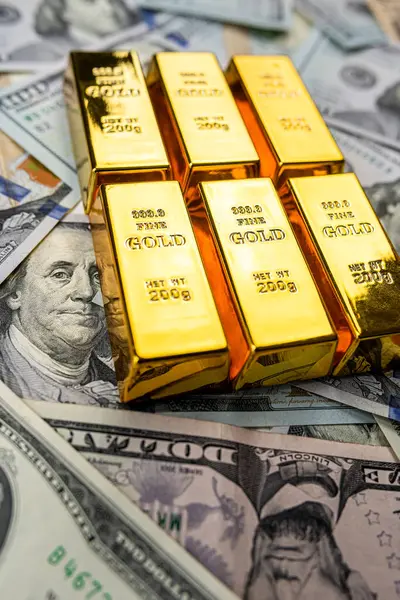 Gold Bullion on us dollar money. Wealth savint or financial concept