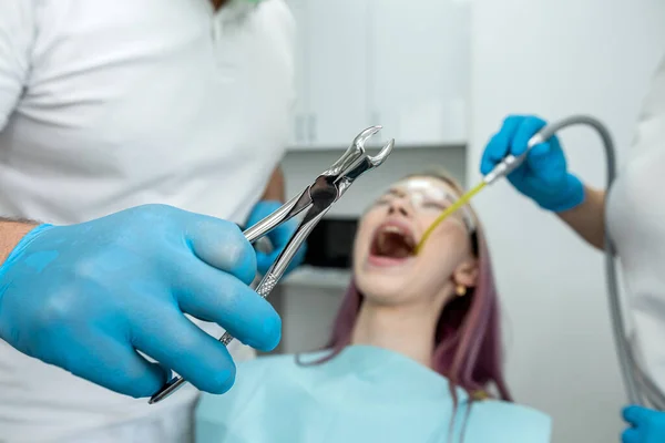 Young Woman Has Her Teeth Treated Male Dentist Female Assistant — Stok fotoğraf