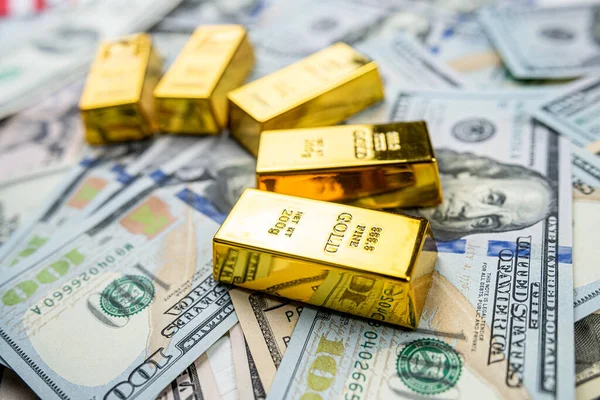 Gold Bullion on us dollar money. Wealth savint or financial concept