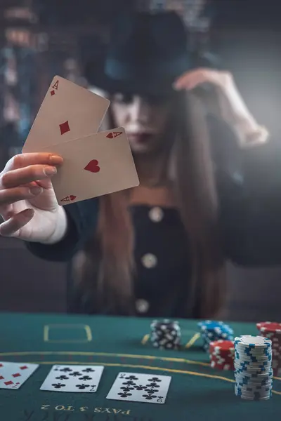 Woman before winning at poker  game with two aces in hand  at gaming table. Luck and fortune