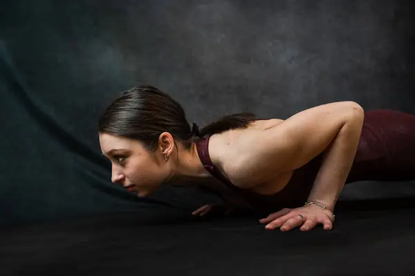 Caucasian woman trainer doing yoga warming up exercises support balancing pose. Sport for health lifestyle