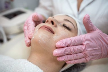 Beyaz kadın spa salonunda yüz masajı yaptırıyor. Vücut bakımı konsepti.