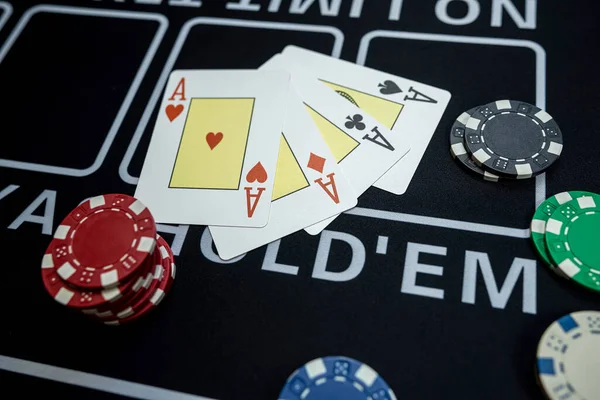 The winning combination is four aces cards and chips on casino table. Poker game