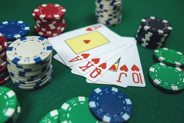 Royal flush combination in five poker card with chips at casino table. Gambling,  blackjacks cards
