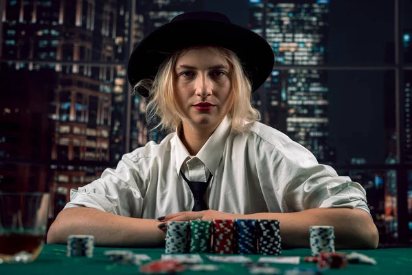 young girl player came to the casino to play poker with cards and chips. poker. casino. female hands