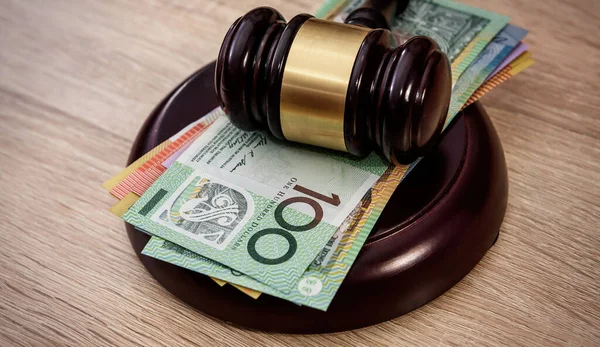 Judge gavel on australian money, law. Mallet of justice concept. Finance background