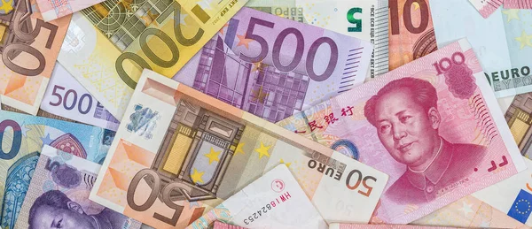 World money - China yuan and Euro paper banknotes. Investment