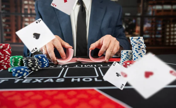 poker croupier holding card to play poker at casino table. Start game, gambling concept