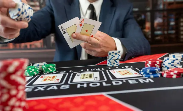 poker croupier holding card to play poker at casino table. Start game, gambling concept