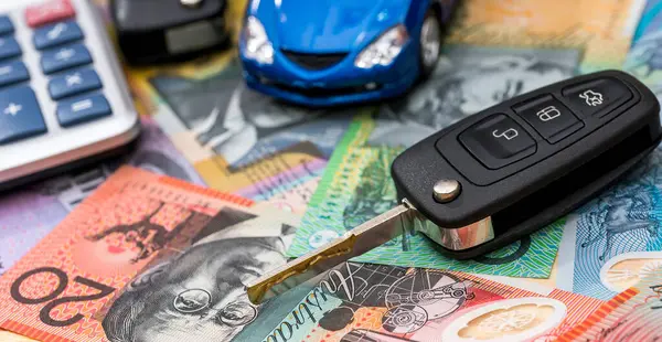 Small blue  toy car with key on aud australian dollar bills, rent or sell vehicle concept