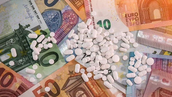 Medical pills tablets on euro paper money. Pharmaceutical industry, very expensive