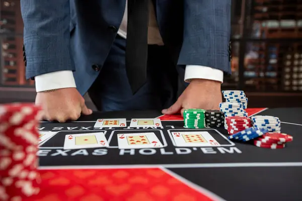 lucky guy in suit hold card and chips play poker at casino. Gambling concept