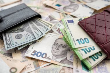 Money 100 dollars and  100 euros in wallet vs 500 1000 ukrainian hryvnia. exchange concept. UAH  
