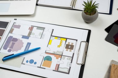Ofis masasında mavi baskı, malzeme rengi örnekleri ve diğer sanat aletleri var. Ev yenileme kavramı