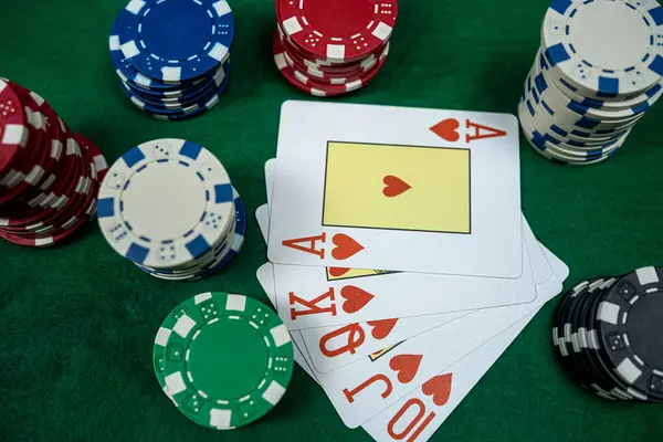 Perfect combination playing cards for win at poker with stack of chips on casino club table. Nobody, gambling