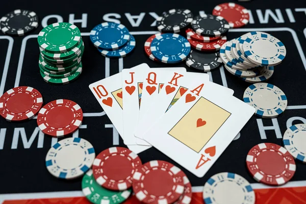 The winning combination  Royal flush with chips at casino table. Gambling concept