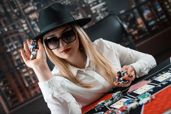 young woman makes a bet with chips in a poker game in a casino. Jackpot, gambling concept