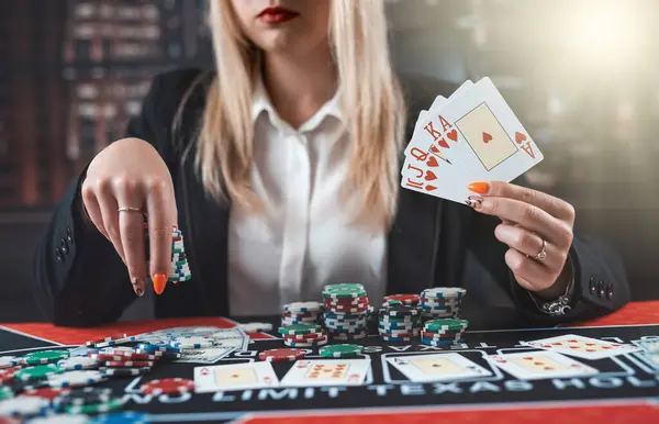 Caucasian pretty woman holding the winning combination of poker cards. Gambling concept, poerk card and casino chips