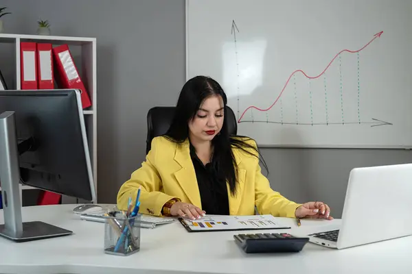Business woman doing math finance or tax, annual report with financial documents and laptop at office. Accounting  statistics concept