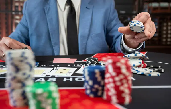 lucky guy in suit hold card and chips play poker at casino. Gambling concept