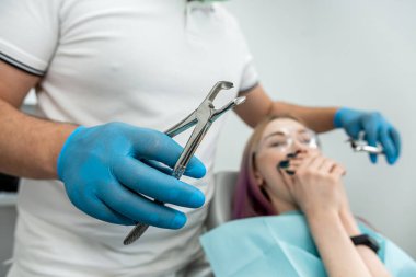 Upset woman with a phobia having a panic attack in the clinic. Fear of the dentist or fear of the doctor. Scared and nervous patient in the hospital.