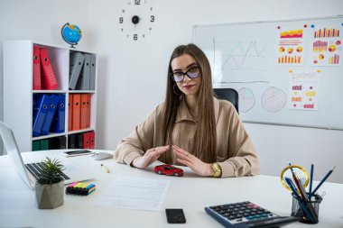female hand above toy car as car insurance concept, protection of vechicle. Workplace