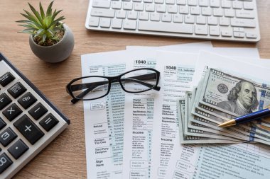 Ofis masasında bilgisayar klavyesi ABD Doları Kalem 1040 vergi formu. Vergi zamanı kavramı