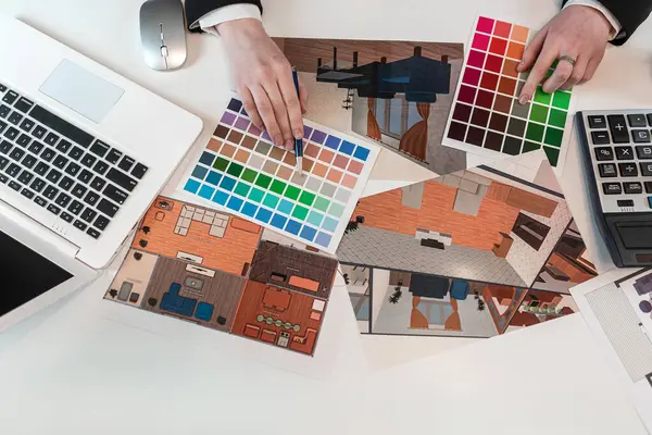 hand of architect chooses color for interior, house  plan sketch, creative workplace. Renovation concept
