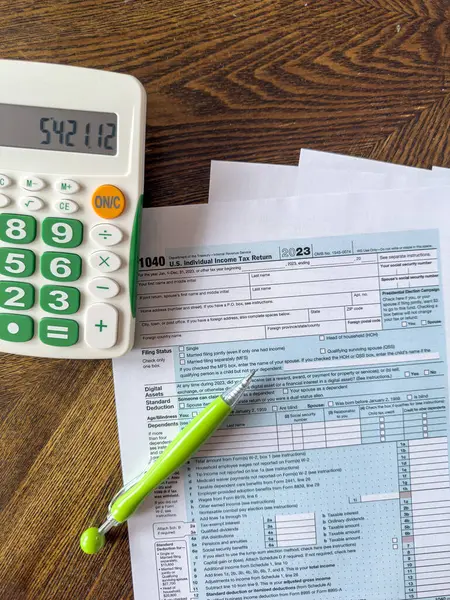 tax form us business income with pen and calculator at office desk. US Individual income tax return
