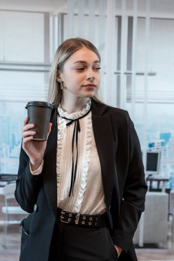 Modern ofis merkezinde boş zamanlarında kahve ile kahve içen genç ve çekici bir kadın, öğle yemeği molası. Yaşam biçimi