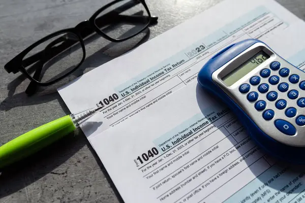 Time to pay taxes concept 1040 tax form pem glasses calculator. April time for tax