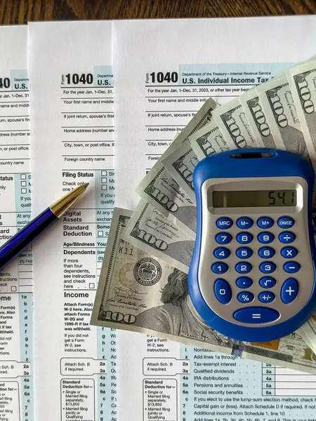 Blank Tax Return Form 1040 and Calculator Pen Dollar. The time to pay taxes