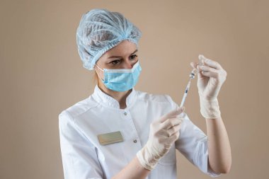 caucasian woman doctor on nurse in full medical uniform prepare syringe with medication for vaccine isolated. Vaccination and immunization concept