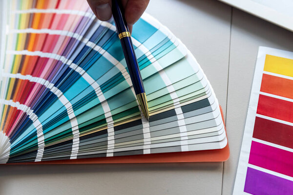Interior designer show wuth pen color and paint swatches palette. The concept design work