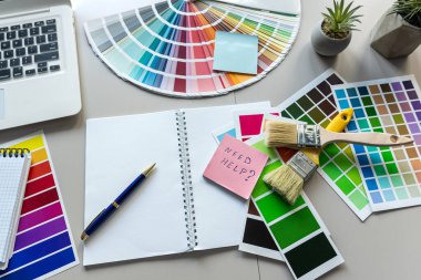 Renk paleti, dizüstü bilgisayarı, gözlük defteri ve kalemi olan bir tasarımcı çalışma alanı. Yaratıcı grafik tasarımcı çalışma alanı