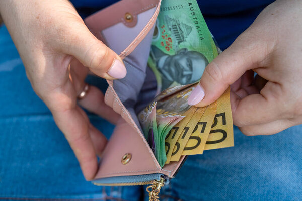 female hand hold new one hundreds and fifty Australian dollar AUD aussie money. Saving concept