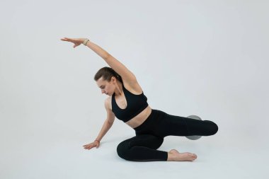 Beyaz arka planda esneme egzersizi yapan güzel bir fitness kadını. Sağlıklı yaşam kavramı 