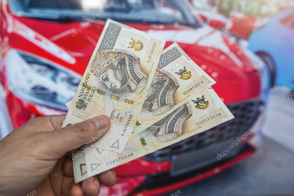 Insurance, loan and buying car in polish pln zloty money in hand. Shopping saving