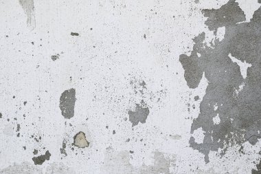 Boya soyan eski bir duvar. Beton ve alçı dokusu. Çatlak, sıyrık ve eşitsizlik içeren soyut vintage grunge arkaplan.