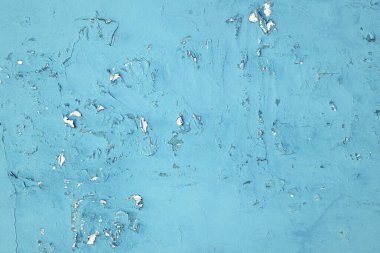 Soyut arkaplan. Eski turkuaz duvarın dokusu soyulmuş, çatlak boyalı..