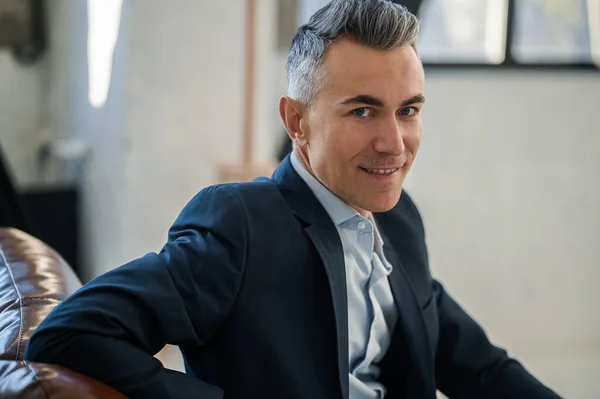 stock image Businessman. Mid aged good-looking man sitting in the office and looking confident