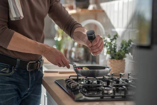 stock image Cooking breakfast. Man cooking something in the kitchen